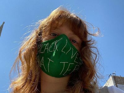 The mask Colby Minifie is wearing is green in color and has Black Lives Matter written on it.